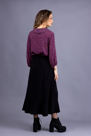 Helmi Peter Pan collar blouse in magenta viscose, back view, full length view, with Rosalie skirt in black