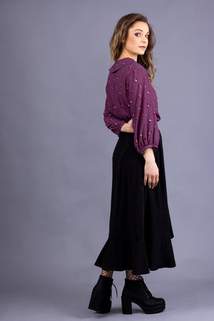 Helmi Peter Pan collar blouse in magenta viscose, side view, full length view, with Rosalie skirt in black