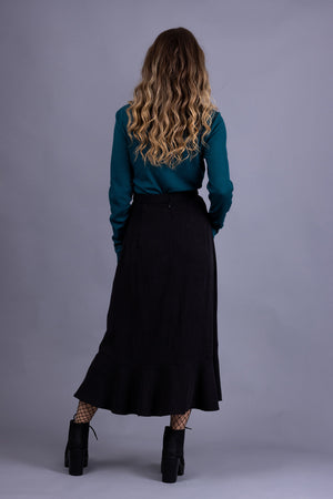 Rosalie darted midi skirt in black tencel twill, with turquoise rib knit top, back view
