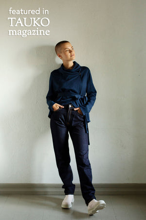 Short Kirsi cardigan in navy, worn closed, with dark jeans, front view