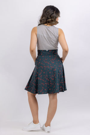The Natalie skirt, a flared gored skirt pattern, made in green floral fabric, back view showing shaped waistband
