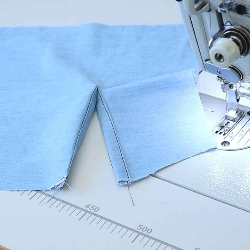 Sewing sample of a continuous bound placket in blue fabric
