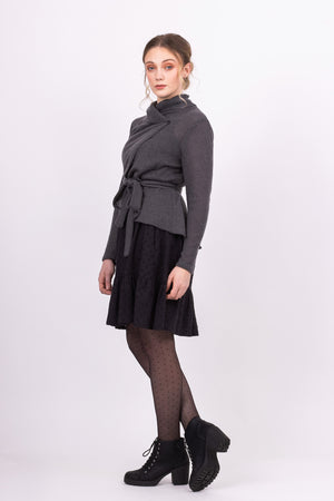 Short Kirsi cardigan in grey, worn closed, with black Ella skirt,  side view
