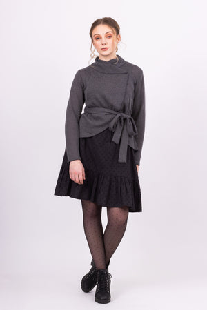 Short Kirsi cardigan in grey, worn closed, with black Ella skirt, front view