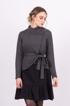 Short Kirsi cardigan in grey, worn closed, with black Ella skirt, front view, close up