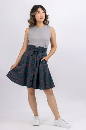 The Natalie skirt, a flared gored skirt pattern with buttons, made in green floral twill, front view.