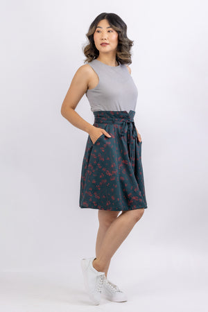 Natalie flared gored skirt pattern from Forget-me-not Patterns in green floral fabric, side view showing slash pocket