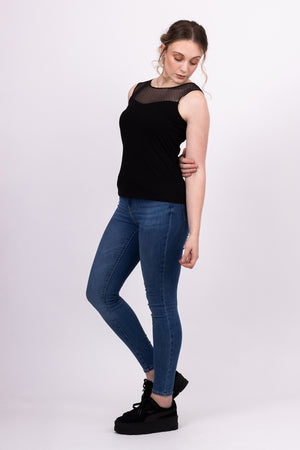 Sylvie knit top with black mesh contrast yoke, worn with blue jeans, side view