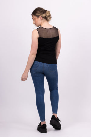 Sylvie knit top with black mesh contrast yoke, worn with blue jeans, back view