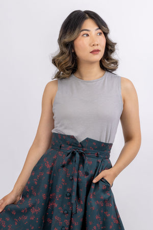 Sylvie knit top in grey modal, round neck view, sleeveless, with Natalie gored skirt in green, close up view