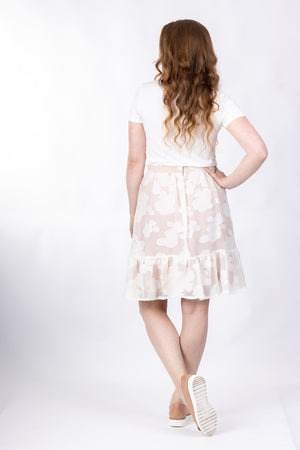Forget-Me-Not Ella short skirt pattern in cream floral, full-length rear shot of model